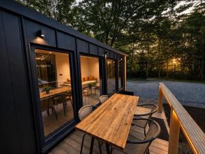 a wooden table on the deck of a tiny house at Wild Crib Avrig in Avrig
