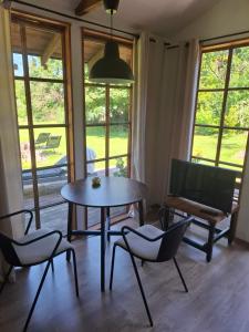 a dining room with a table and chairs and a couch at dom & weranda in Szczęsne