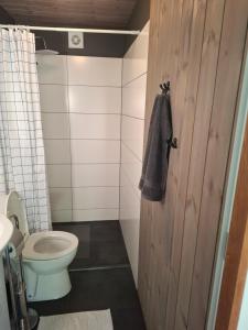 a bathroom with a toilet and a towel on the door at dom & weranda in Szczęsne +16 photos
