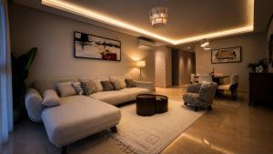 a living room with a couch and chairs and a table at ZED Towers City View Apartment in Sheikh Zayed +2 photos