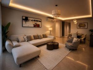 a living room with a couch and a table at ZED Towers City View Apartment in Sheikh Zayed