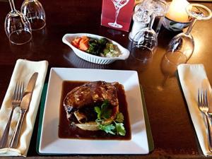 a table with a plate of food on a table at The Boot and Shoe in Greystoke