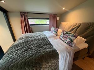a bedroom with a bed with pillows and a window at The Dream Factory in Andøya