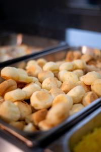 a tray of buns sitting on top of sidxternessternessstrationstrationstrationstration at Manacá Hotel in Foz do Iguaçu +46 photos