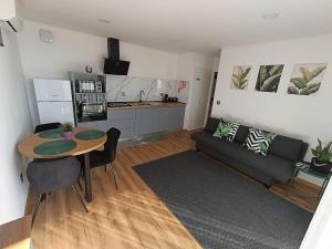 a living room with a table and a couch at Refúgio D'Aguiar in Aguiar da Beira