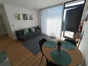 a living room with a table and a couch at Refúgio D'Aguiar in Aguiar da Beira