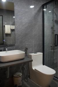 a bathroom with a toilet and a sink and a shower at Tranquil Retreat Dhigurah in Dhigurah