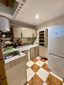 a kitchen with a white refrigerator and a sink at Dar Zagora Oasis - Authentic Moroccan Stay in Zagora +39 photos