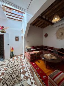 a living room with a couch and a table at Dar Zagora Oasis - Authentic Moroccan Stay in Zagora