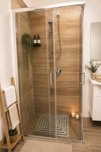 a shower with a glass door in a bathroom at Archivio 32 in Caserta