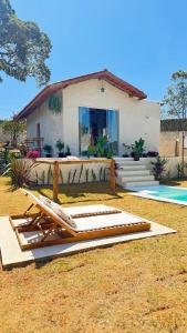 a house with a bunch of beds in front of it at EcoRefúgio Verde - iUna in Ibiúna