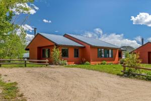 a house with a dirt road in front of it at Indian in Clark