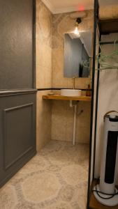 a small bathroom with a sink and a counter at JM Resort Iguazu in Puerto Iguazú