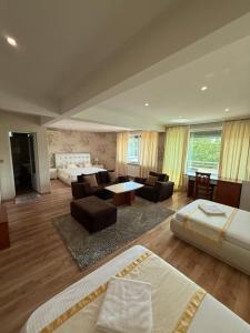 a large room with two beds and a living room at Motel Eros in Sandanski +75 photos