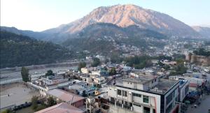 a view of a city with a mountain in the background at AAKAS Hotel & Restaurant in Muzaffarabad