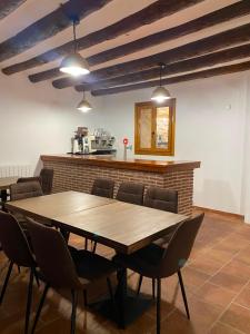 a dining room with a wooden table and chairs at Hotel Casa Manolet 