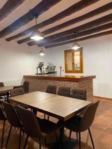a dining room with a wooden table and chairs at Hotel Casa Manolet  +17 photos