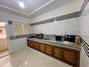 a kitchen with a sink and a counter top at Luxury Apartment Elevator FIBER WIFI in Oujda