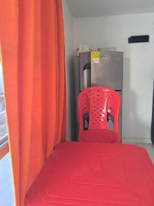 a red seat in a truck with an orange curtain at Cabañas Calipso # 7 in Coveñas