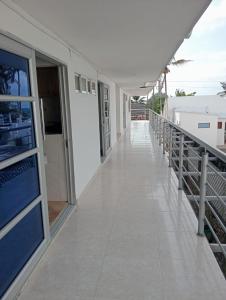a balcony of a building with a walkway at Cabañas Calipso # 7 in Coveñas