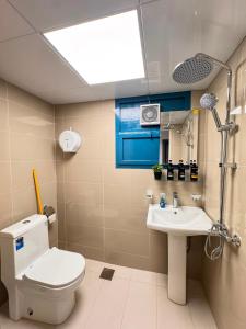 a bathroom with a toilet and a sink at Vogue Inn in Abu Dhabi +25 photos
