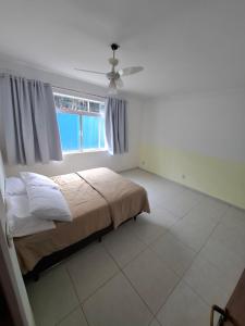 a bedroom with a bed and a window at Casazul in Lavrinhas +16 photos