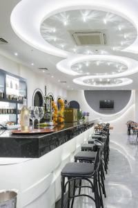 a bar in a restaurant with black stools at Graf Victor Hotel - All Inclusive Non Alcoholic Drinks in Çamyolu