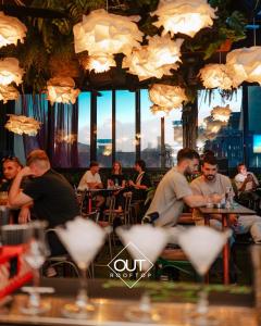 a group of people sitting at tables in a restaurant at Chillout Hostel Zagreb in Zagreb