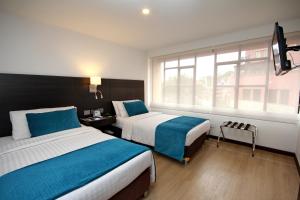 Postelja oz. postelje v sobi nastanitve Hotel Dann Cali