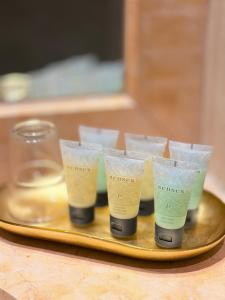 a group of four cups on a tray at Lumi Hotel Eilat - מלון בוטיק באילת in Eilat