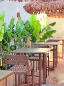 a row of tables and chairs with plants at Lumi Hotel Eilat - מלון בוטיק באילת in Eilat