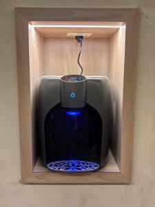 a wooden box with a blue vase in it at Lumi Hotel Eilat - מלון בוטיק באילת in Eilat