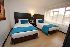 Postelja oz. postelje v sobi nastanitve Hotel Dann Cali