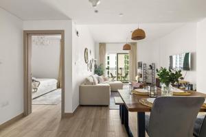 a living room with a table and a couch at Waterfront Yas 1BR near F1 & Ticket Savings in Abu Dhabi