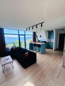 a living room with a couch and a table at Mravaldzali twins in Oni