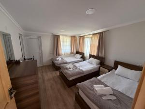 a room with two beds and a couch at Tebdi Qor, Warm Home in Mestia
