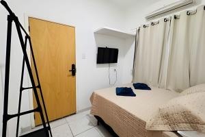 a room with a bed with a ladder and a door at Abaíra Serra Azul Suítes 01 - Centro in Petrolina