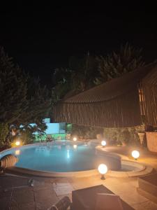 a swimming pool at night with lights around it at Luxury Villas Chrysa Private Pool & Spa in Nafplio