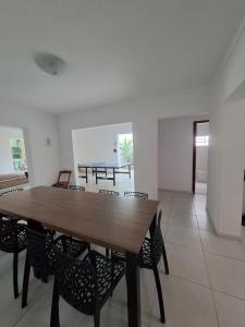 a dining room with a wooden table and chairs at Casazul in Lavrinhas