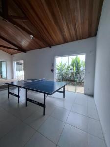a ping pong table in the middle of a room at Casazul in Lavrinhas
