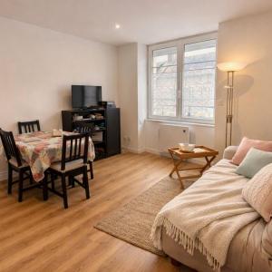 a living room with a table and a dining room at Wapiti apartment in Loctudy