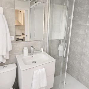 a bathroom with a toilet and a sink and a shower at Wapiti apartment in Loctudy