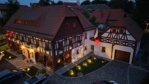 an overhead view of a large house with lights at Pensjonat Dom Zegarmistrza in Bogatynia