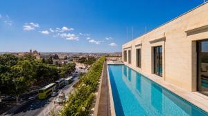 a swimming pool on the roof of a building at St Anne Palace by Tritoni Prestige in Il-Furjana