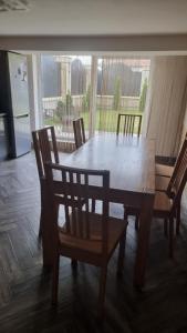 a wooden table and chairs in a room with a window at Гостинний дім in Shom