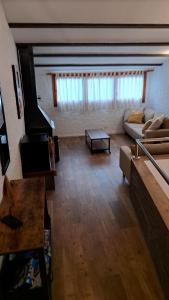 a living room with a couch and a piano at Can Teixidor in Besalú