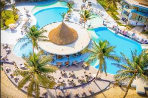 an overhead view of a resort swimming pool with palm trees at m hadji premium in Dakar