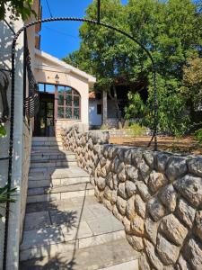 a stone retaining wall in front of a house at Holiday Sparks in Jadranovo