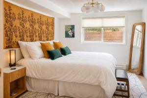 a bedroom with a large white bed and a window at The Nest in Fort Collins