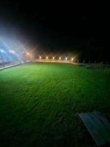 a soccer field at night with lights in the background at Къща за гости Жеглица in Zheglitsa +7 photos